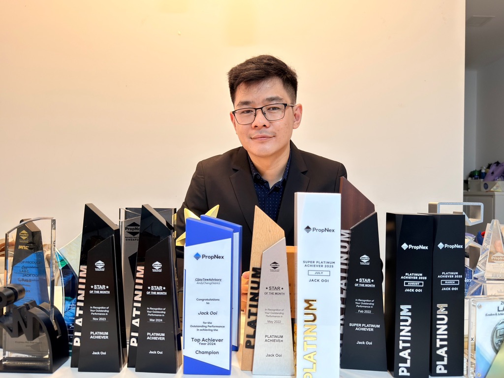 Jack Ooi with a collection of PropNex achievement trophies